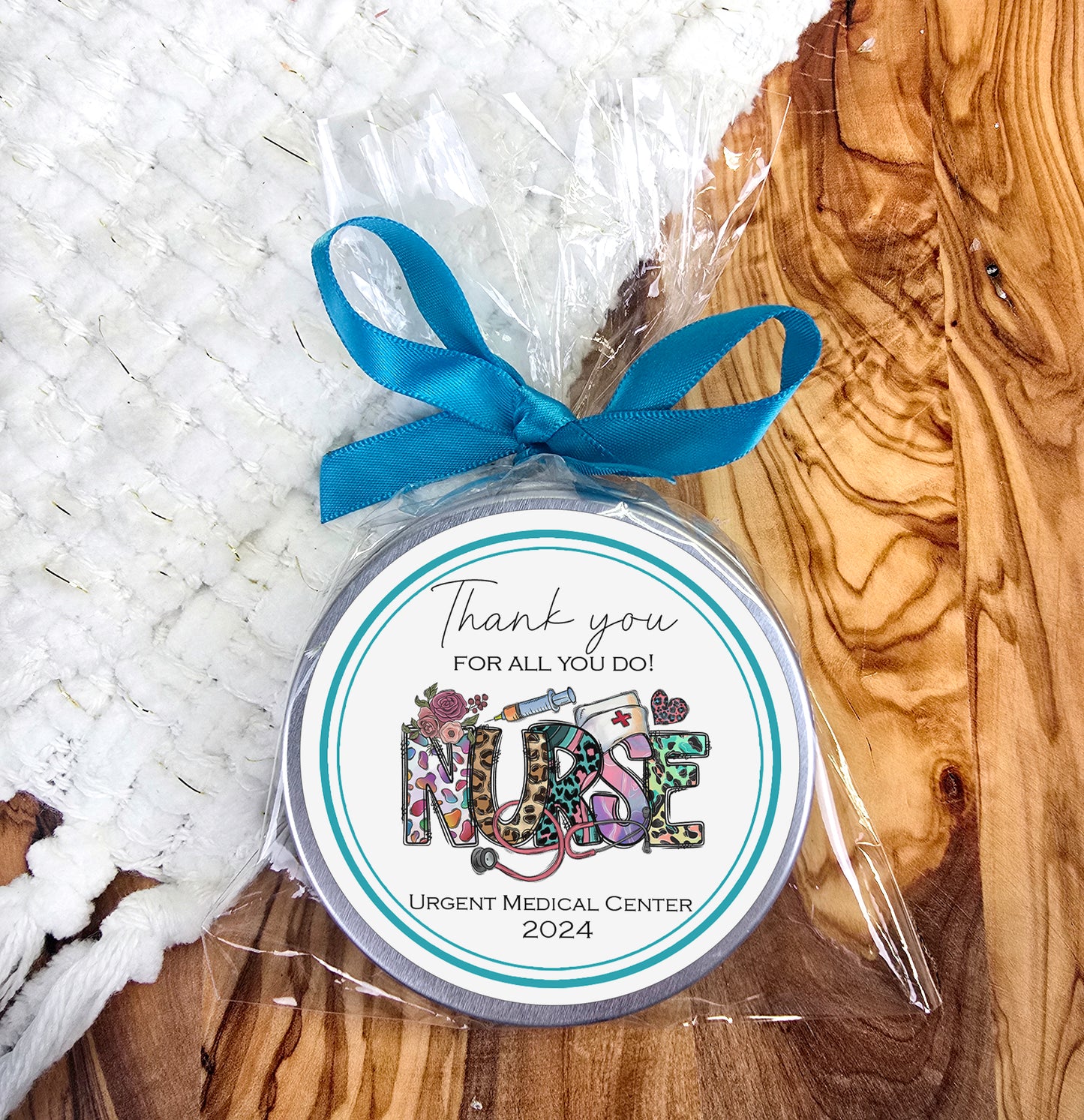 a small jar with a blue ribbon on it