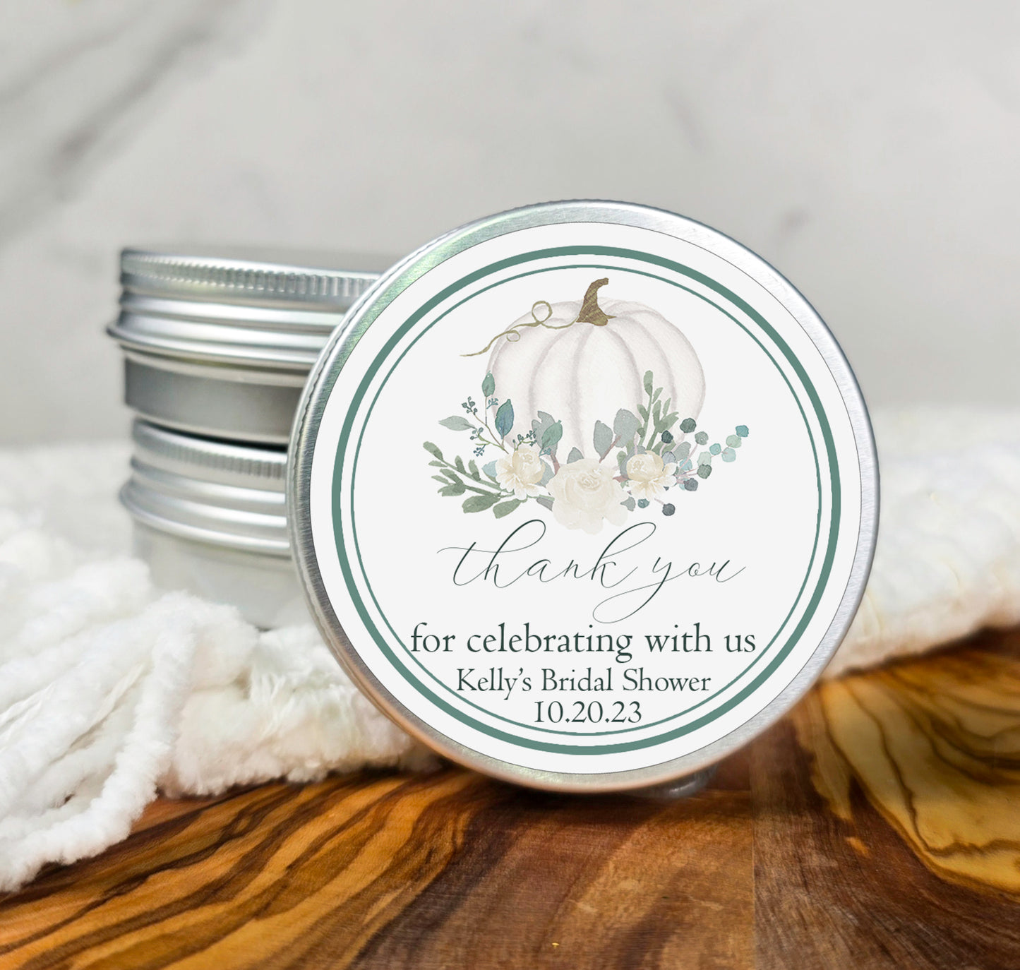 a jar of wedding favors with a white pumpkin on it