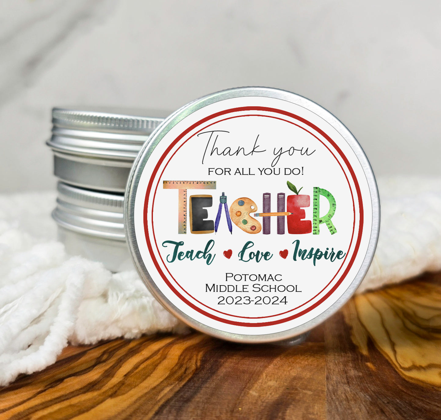 a tin of teacher appreciation lip bale on a wooden table