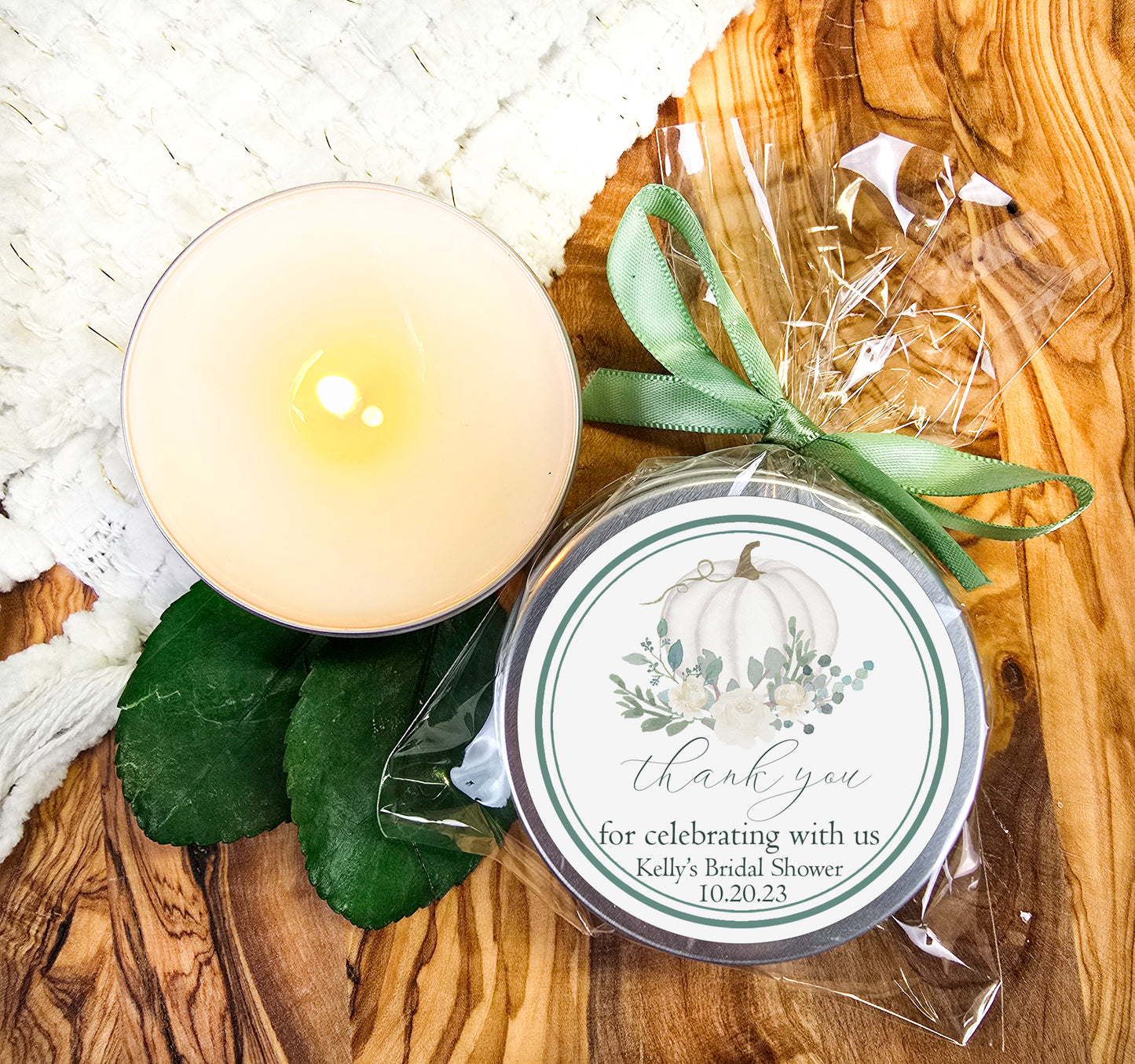 a candle sitting next to a jar of wax on top of a wooden table