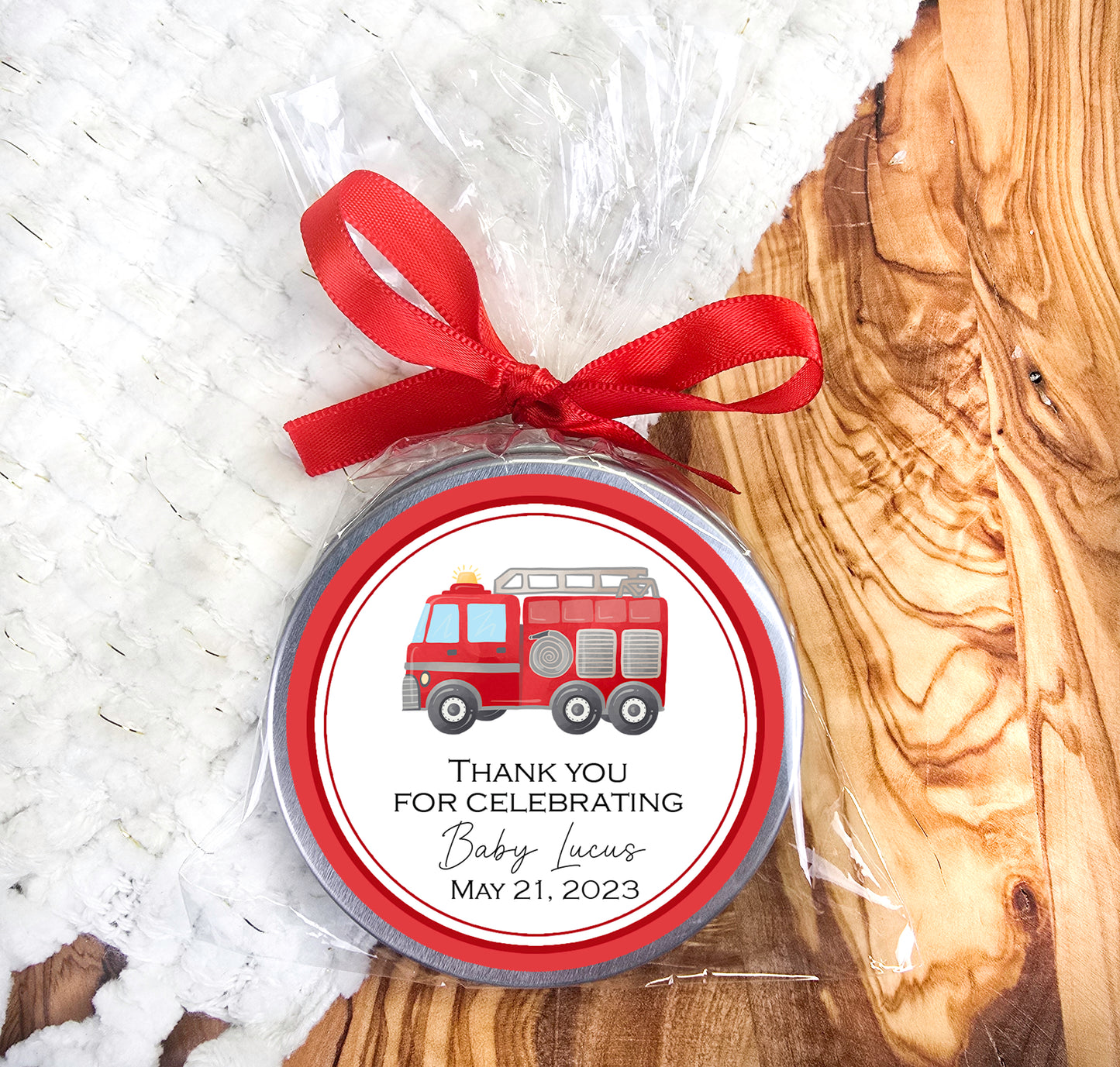a red ribbon is tied around a small jar of thank you for celebrating
