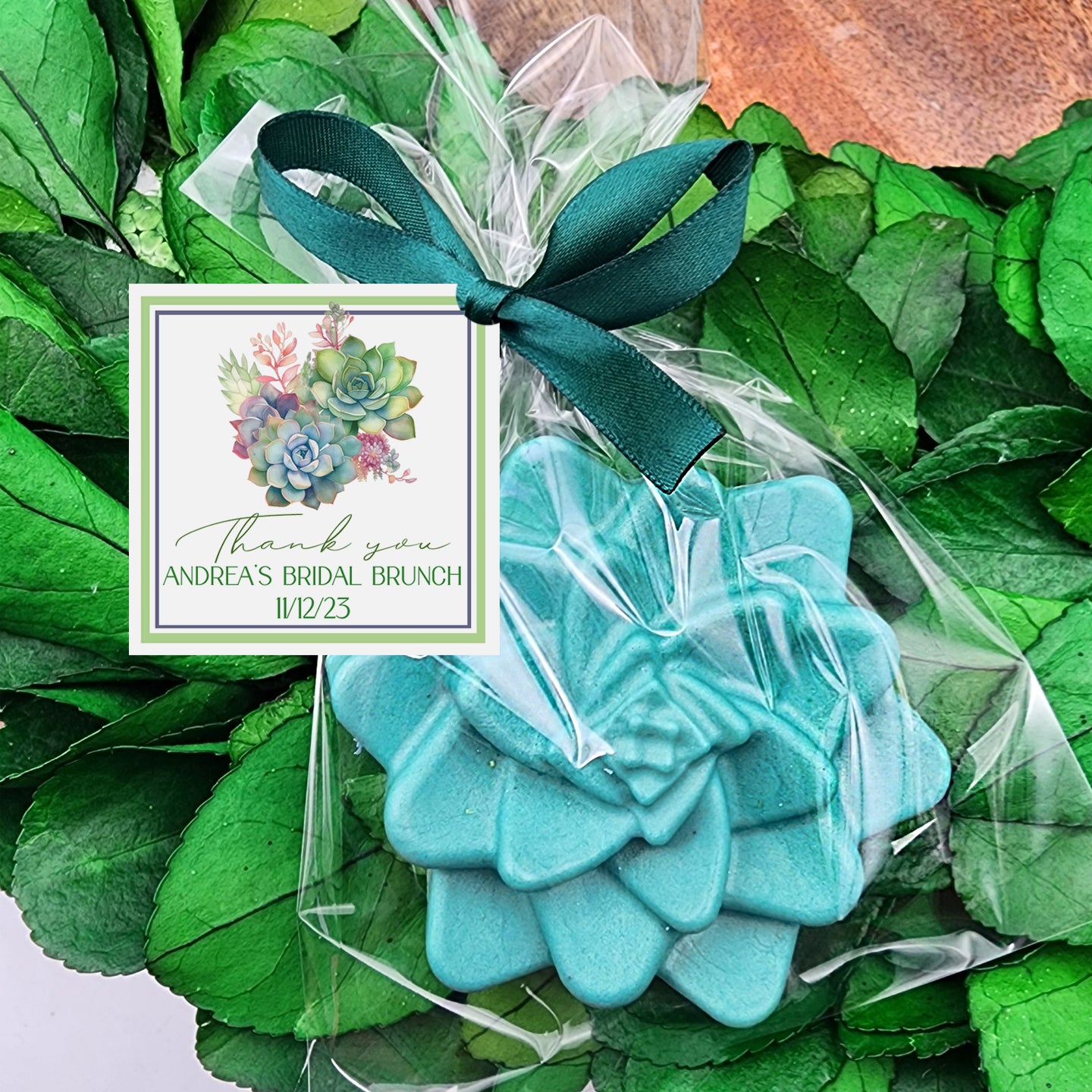 a green wreath with a blue flower on it
