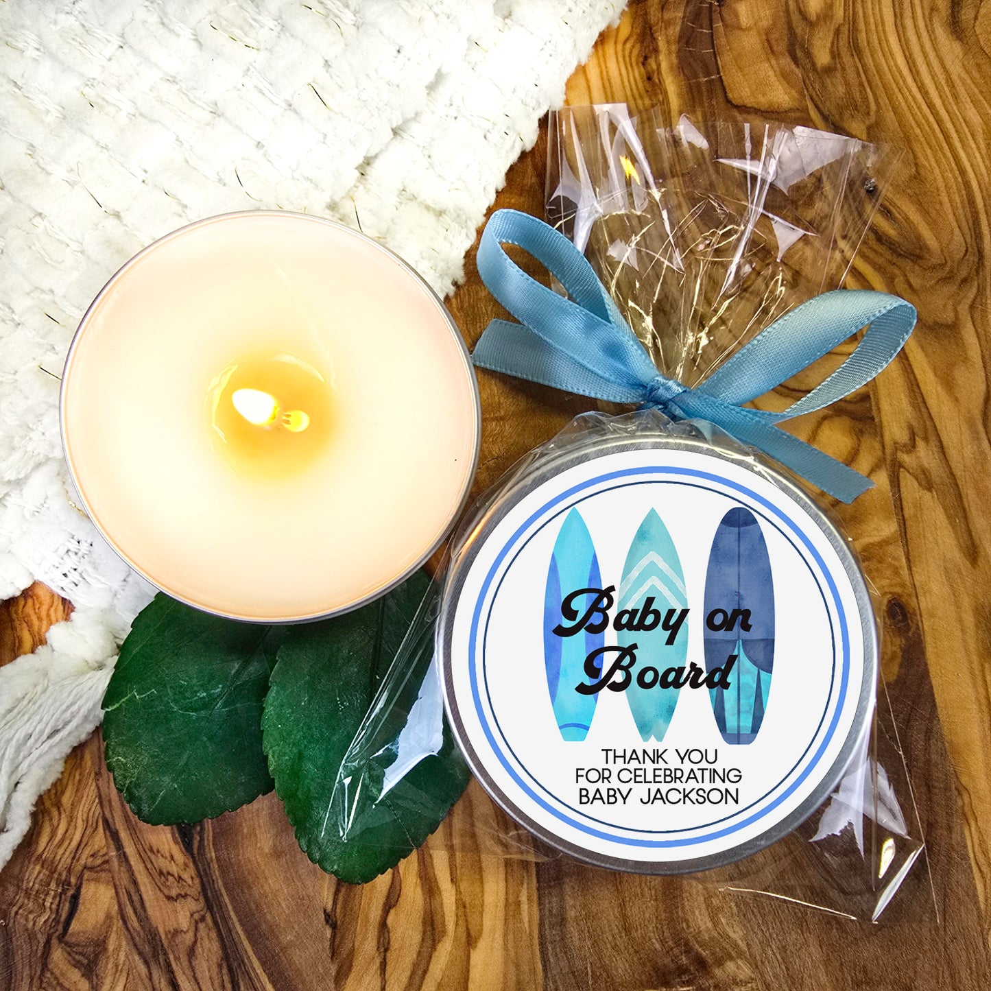 a baby on board candle next to a candle