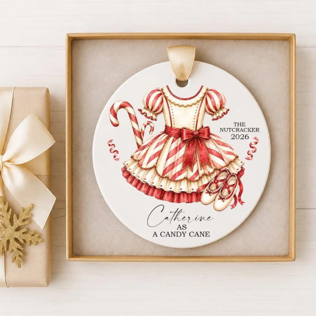 A decorative ornament featuring a red and white striped dress and a candy cane, with the text "The Nutcracker as a Candy Cane" and "Catherine" written on it.