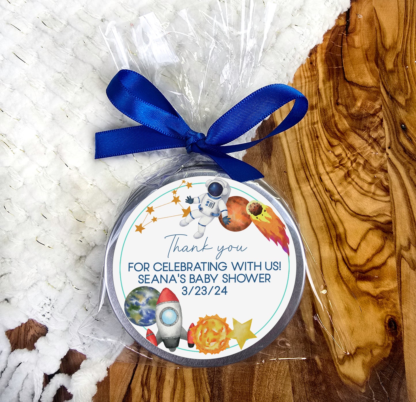 a baby shower ornament with a blue ribbon