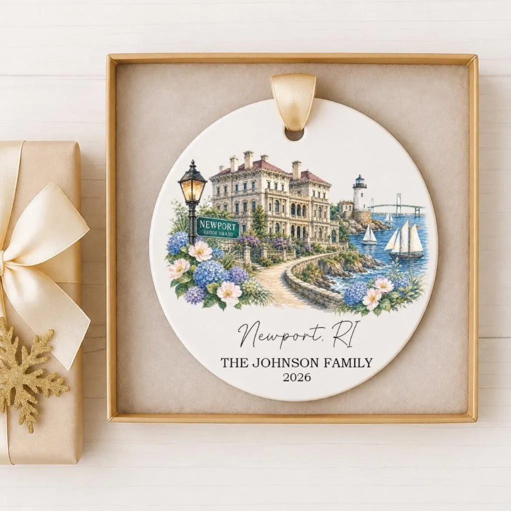 A decorative ornament featuring a painting of a coastal town with a lighthouse, boats, and flowers. The text on the ornament reads "Newport R.I. THE JOHNSON FAMILY 2026".