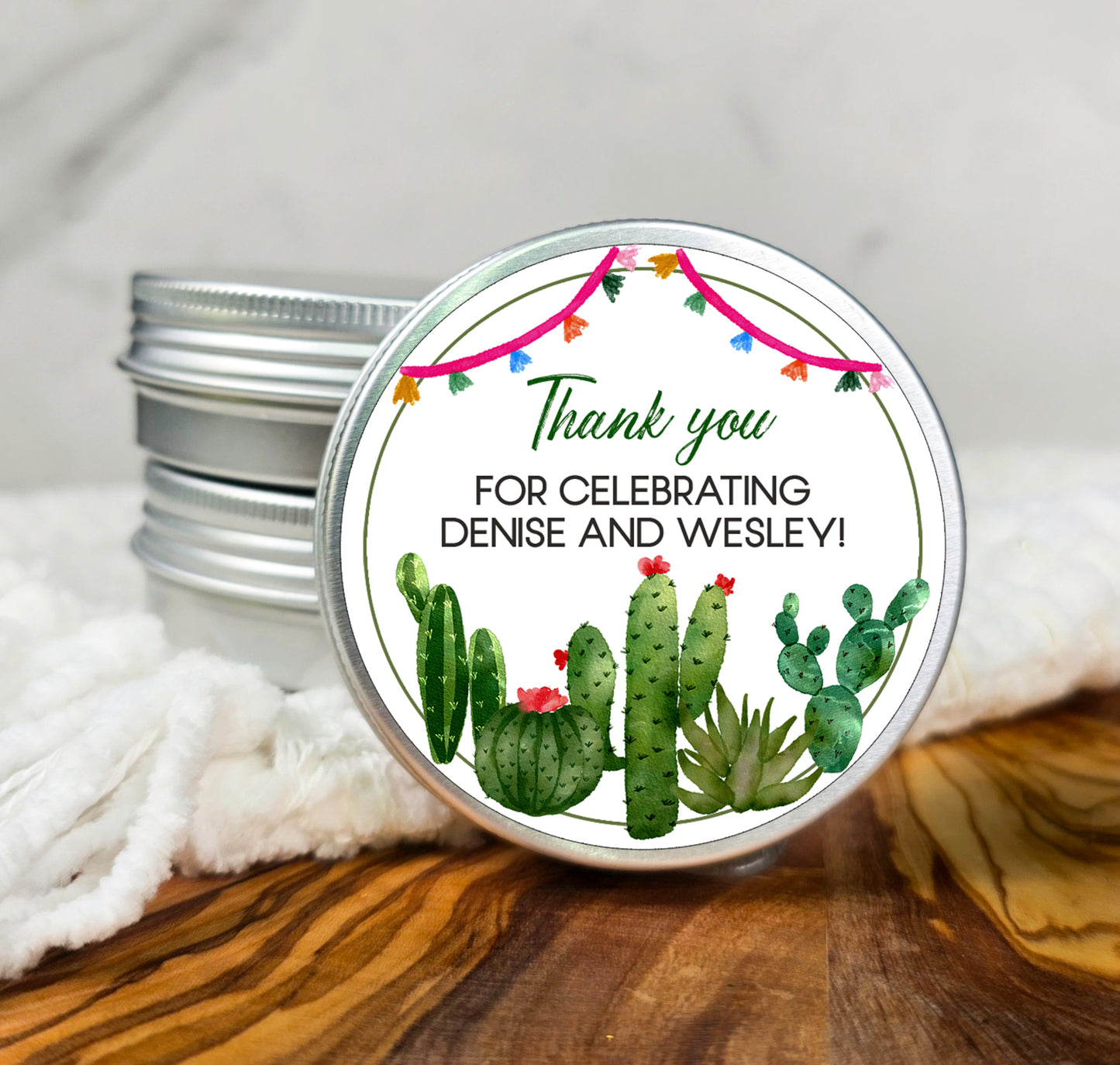 a tin of desert themed candles with a thank you label