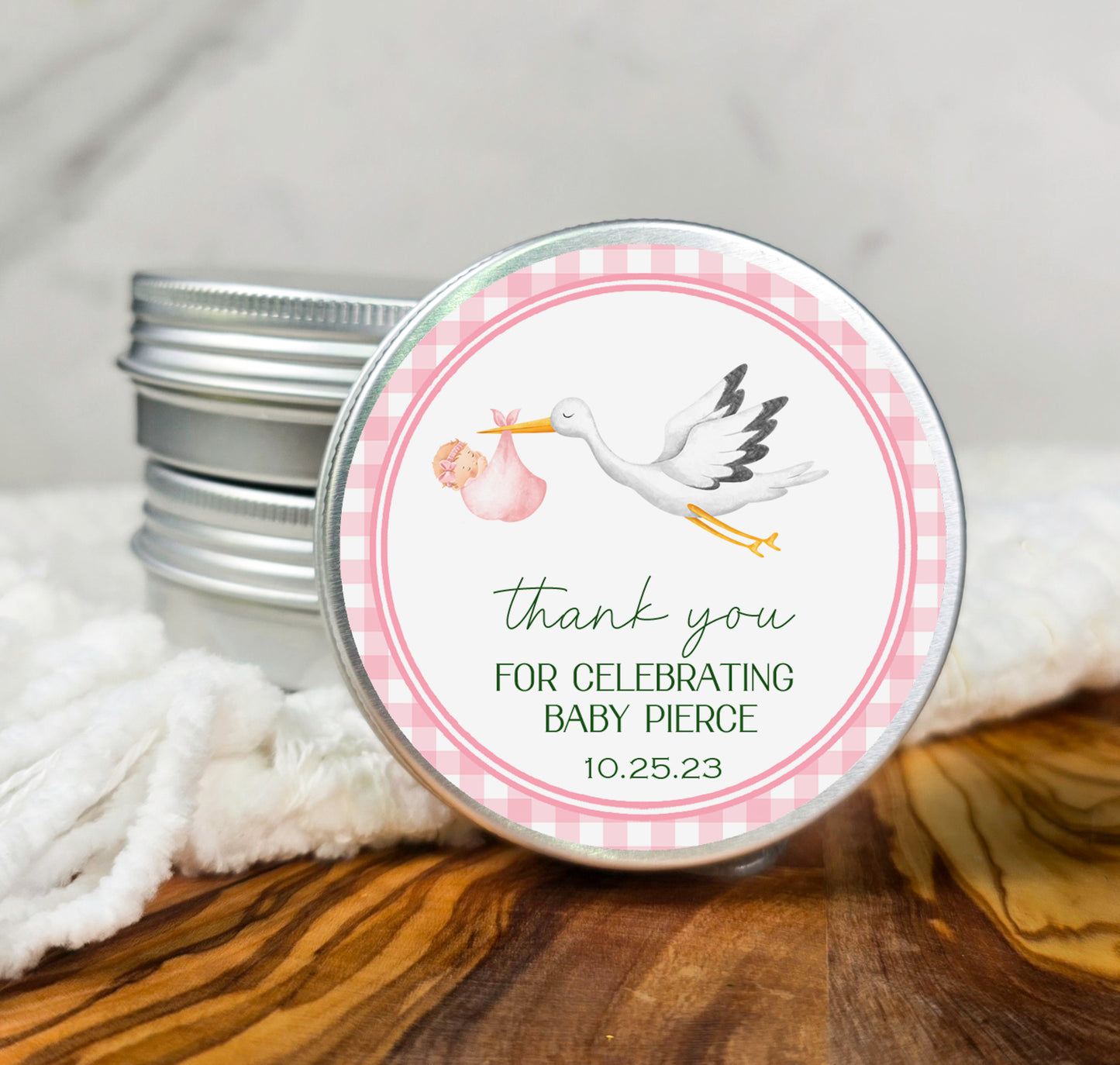 a small tin with a stork design on it