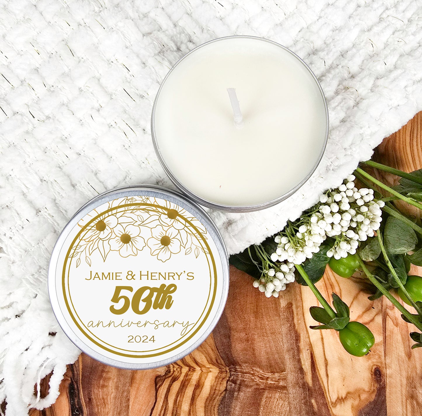 a candle and some flowers on a wooden table