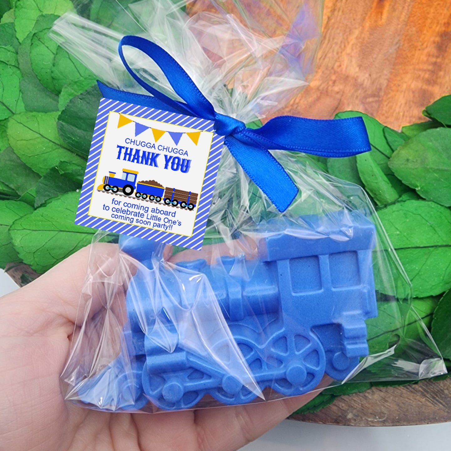 a person holding a plastic train in their hand