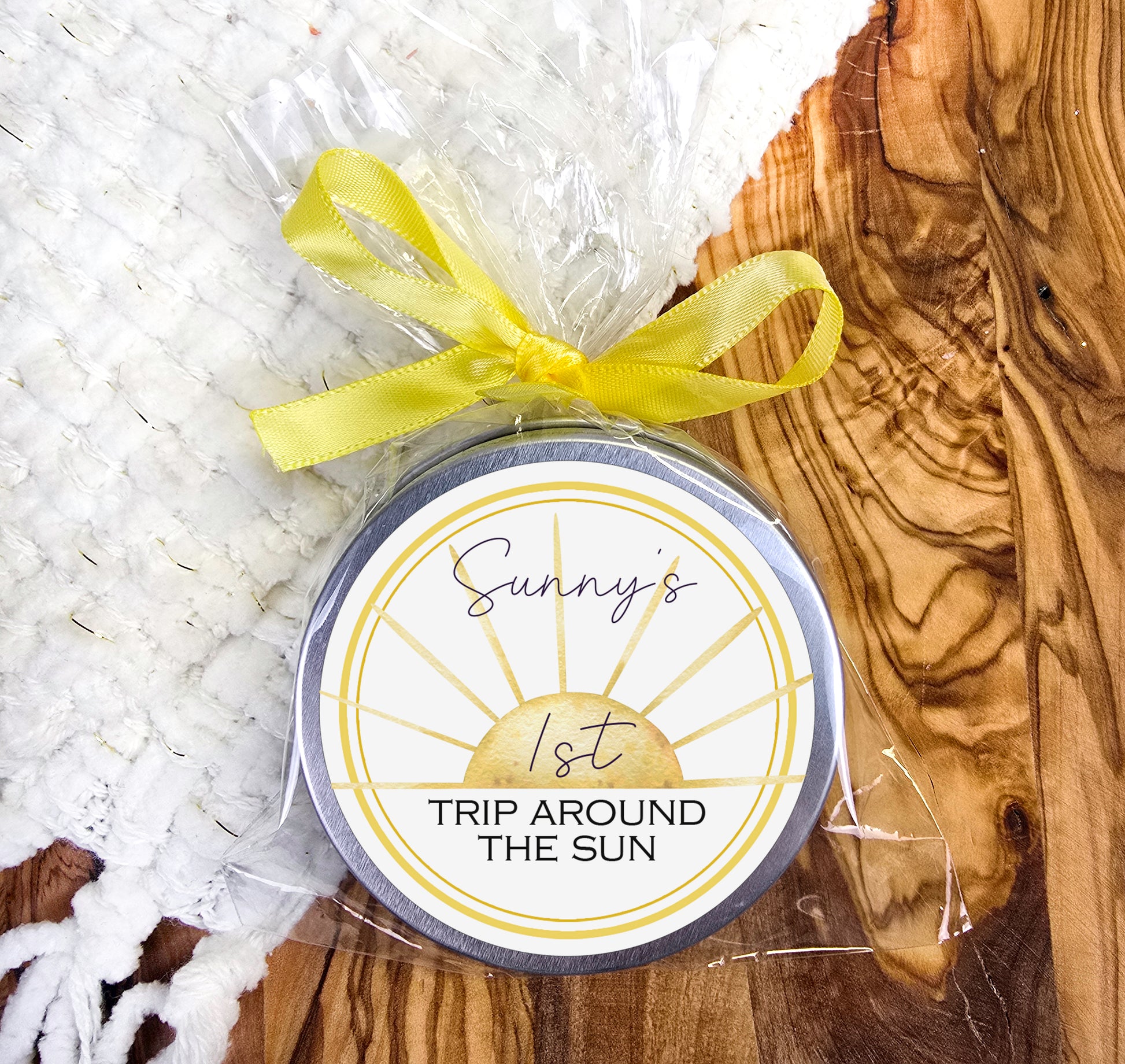 a round tin with a yellow ribbon around it