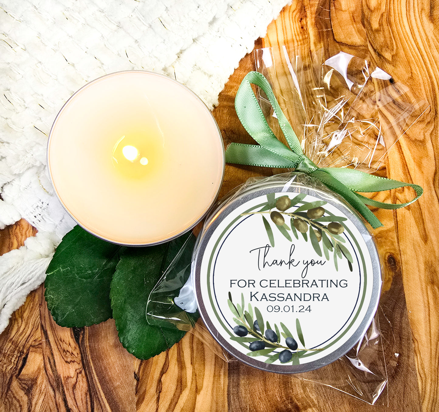 a candle and some leaves on a table