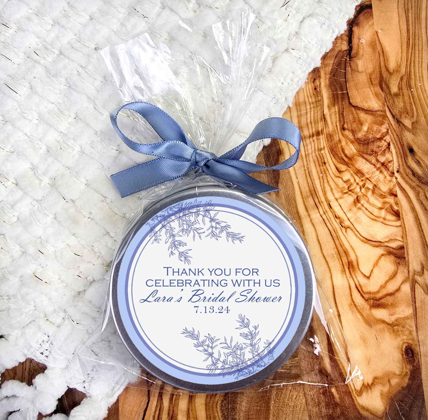 a small tin with a blue ribbon around it
