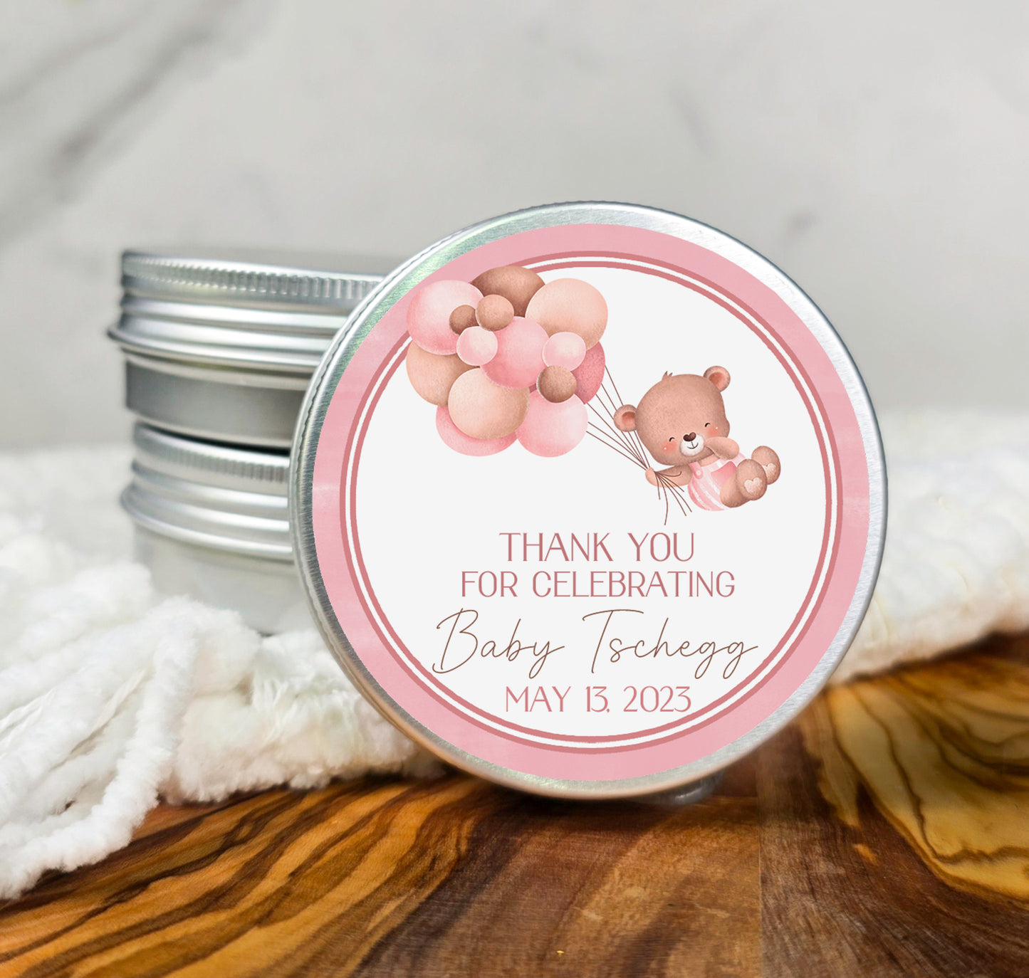 a pink and silver tin with a teddy bear on it