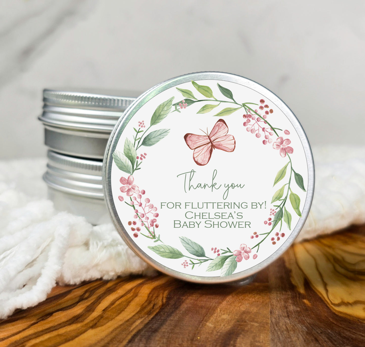 a tin of baby shower soap sitting on top of a wooden table