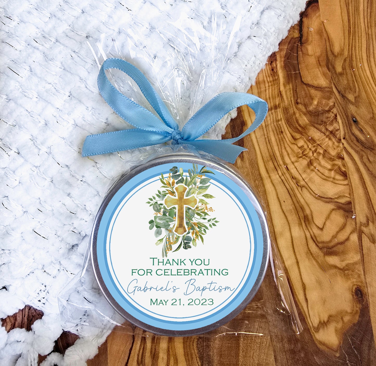 a small tin with a blue ribbon around it