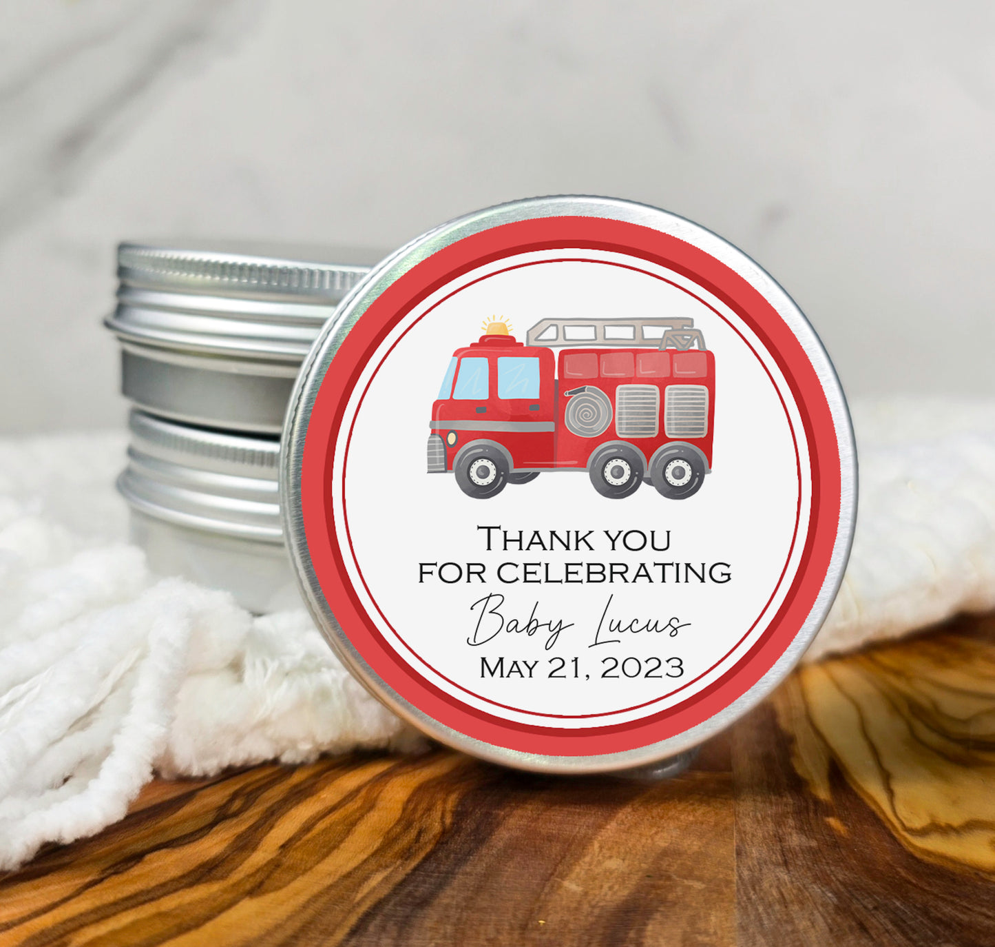 a tin of thank you for celebrating with a fire truck on it