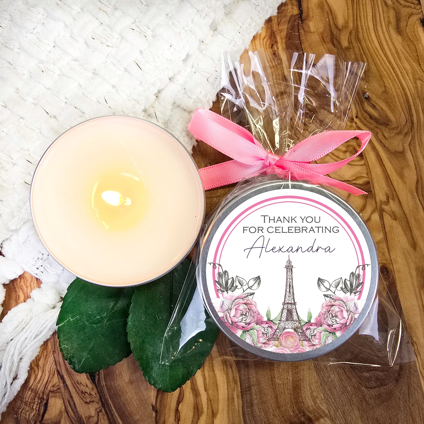 a candle and a package of chocolates on a table