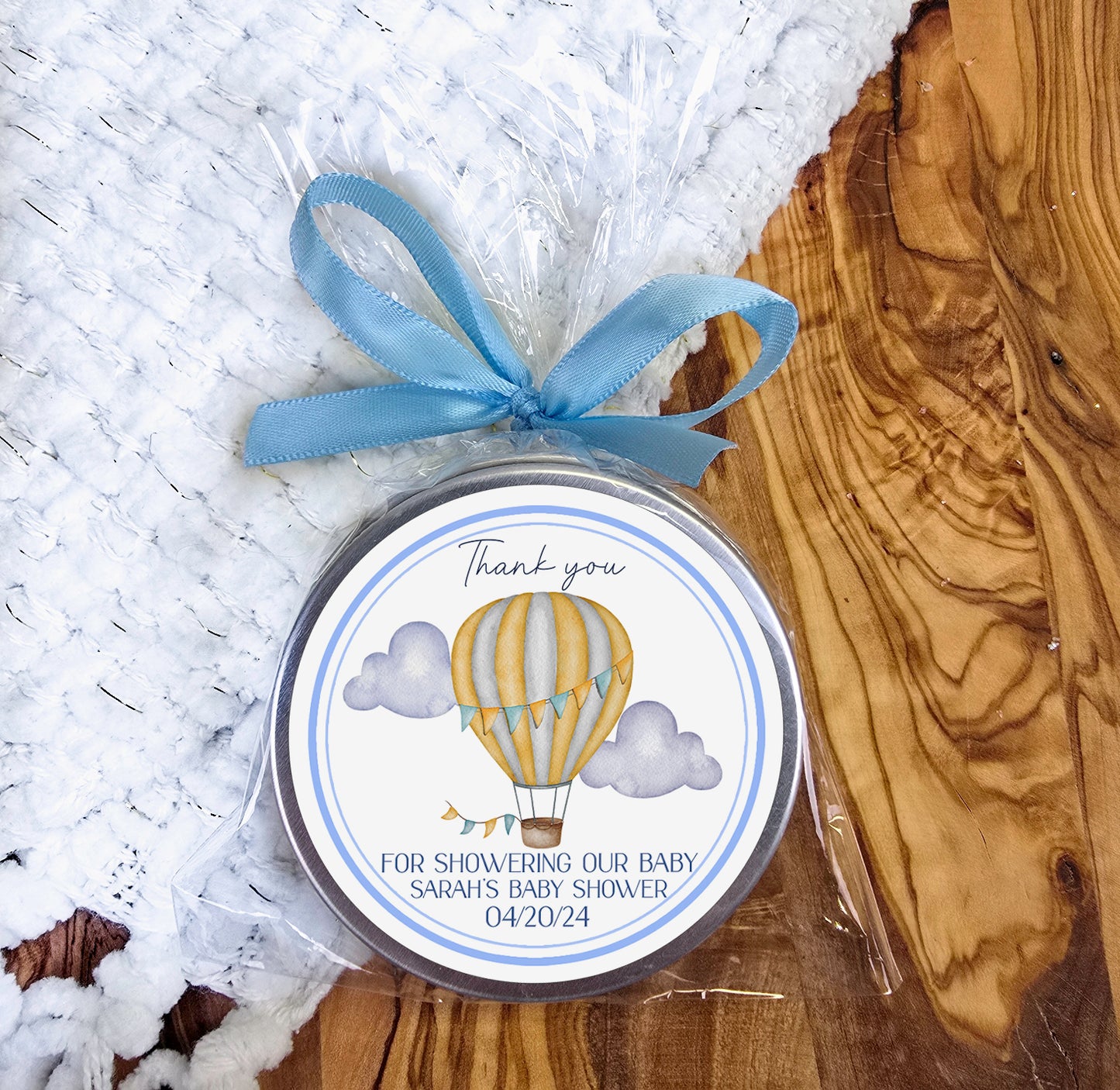 a small tin with a blue ribbon around it