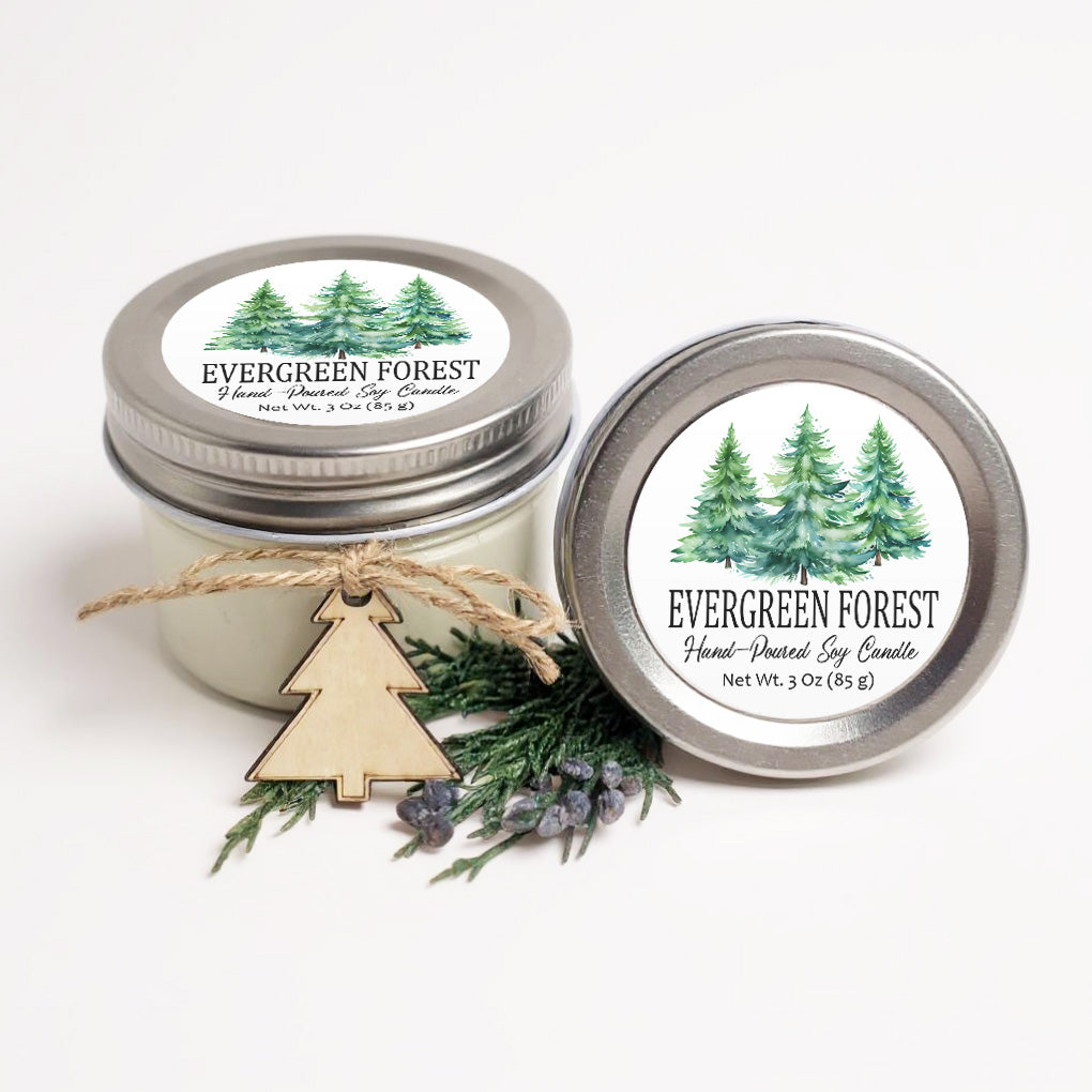 two jars of Evergreen Forest soy candles, one with a wooden tree charm and the other with a silver lid.