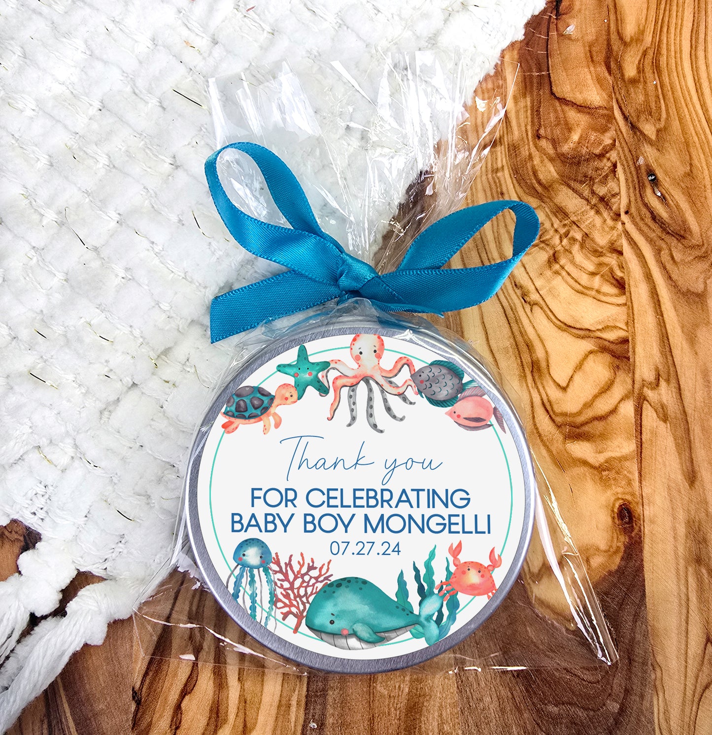a baby boy shower gift with a blue ribbon