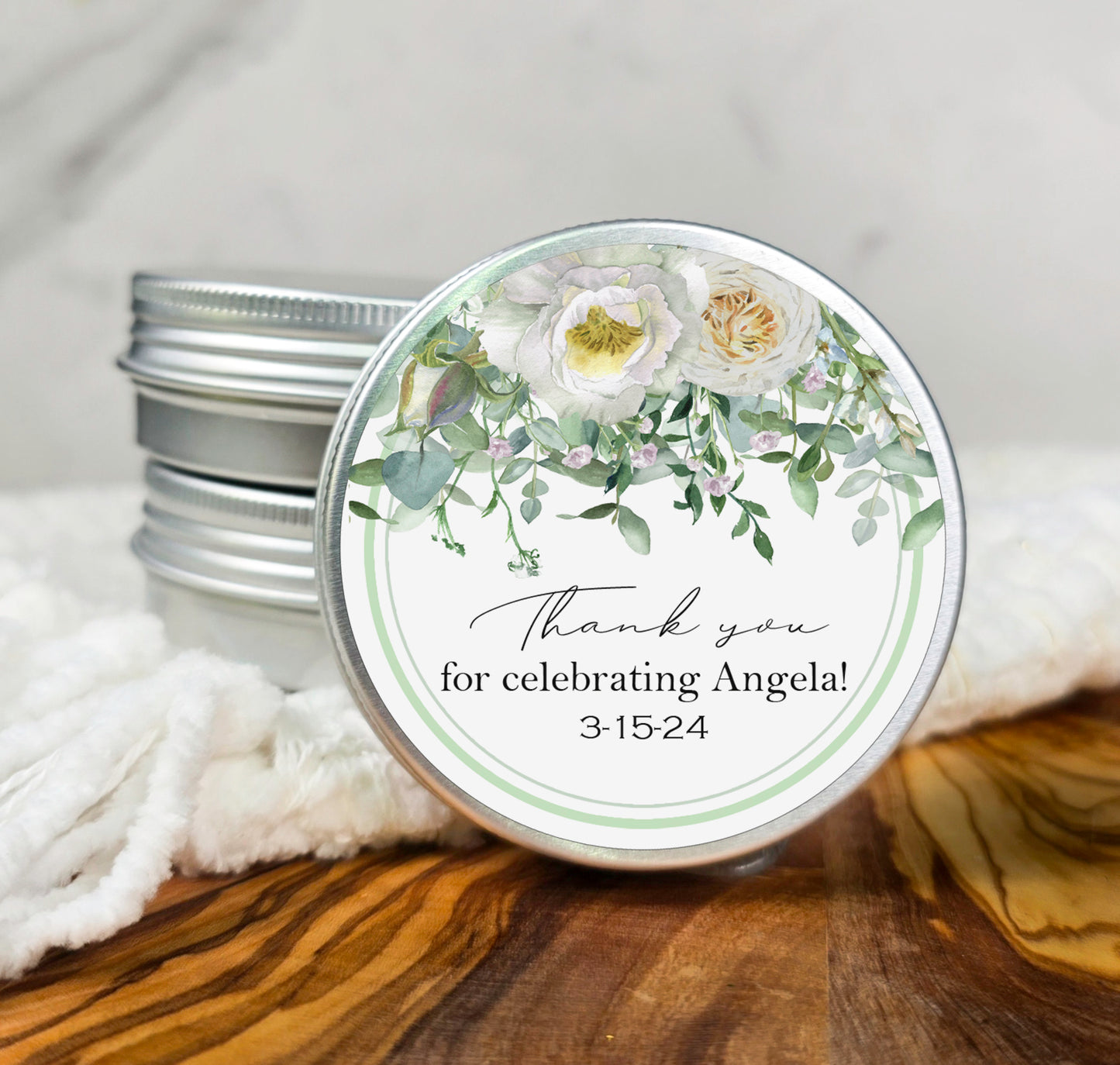 a jar of personalized wedding favors sits on a table