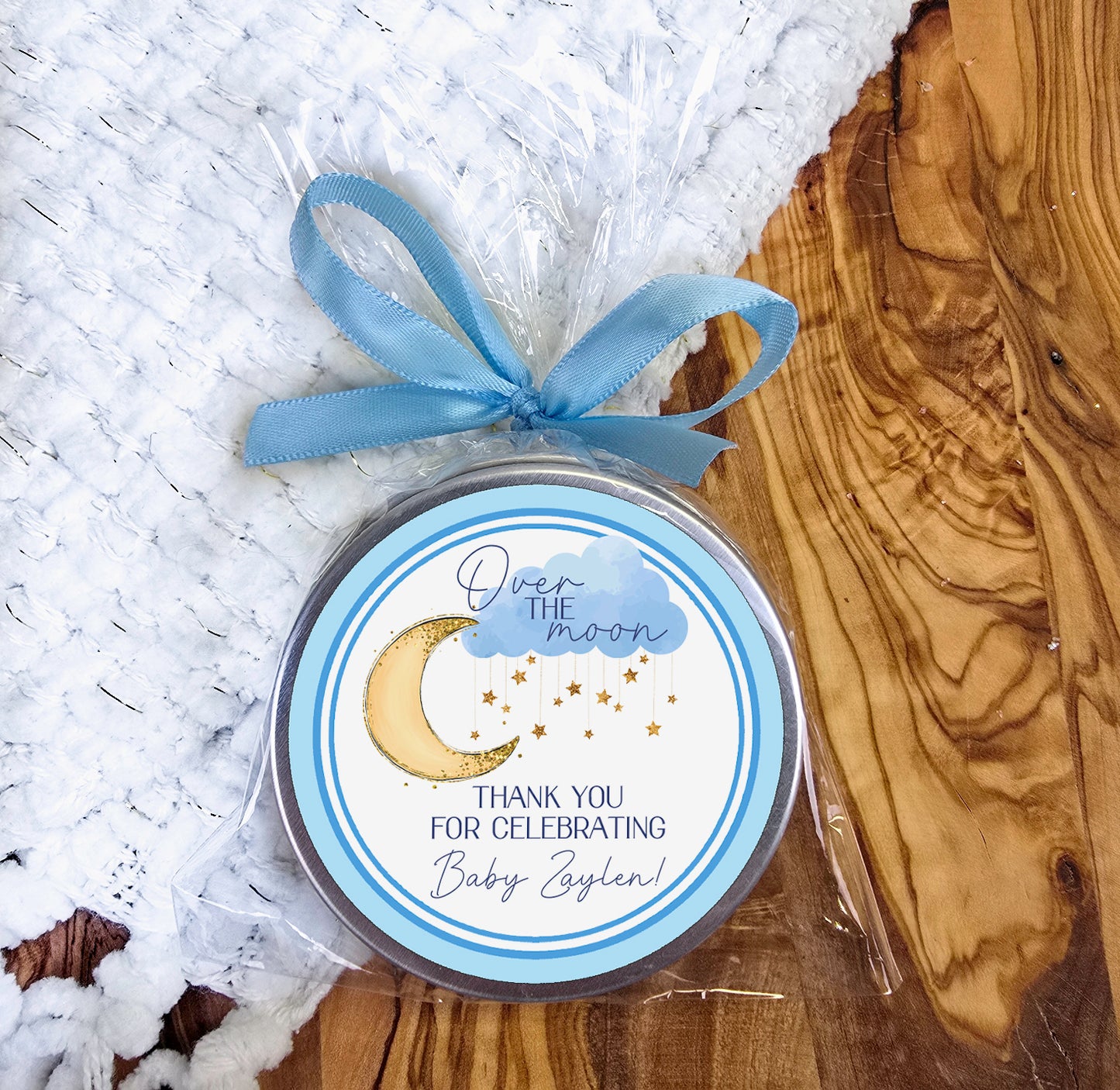 a small tin with a blue ribbon on it