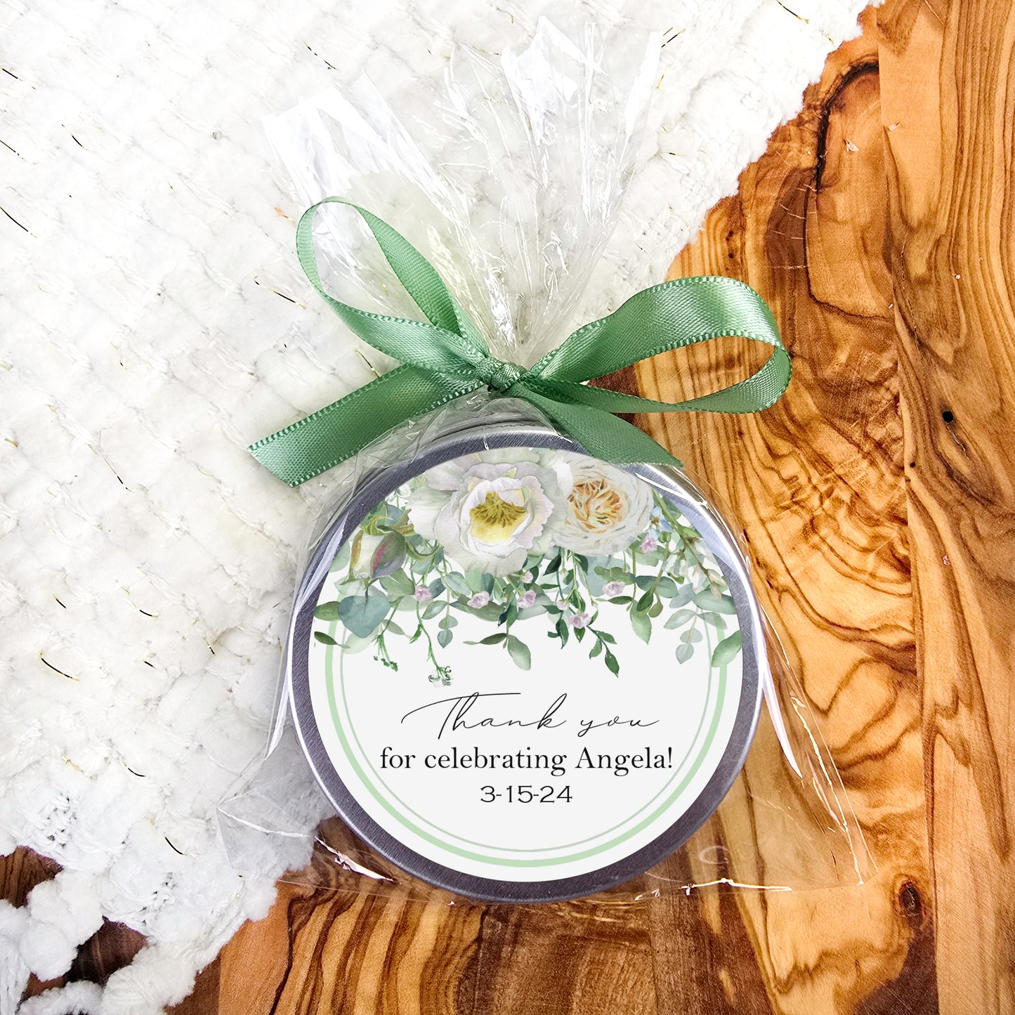 a small tin with a green bow on it