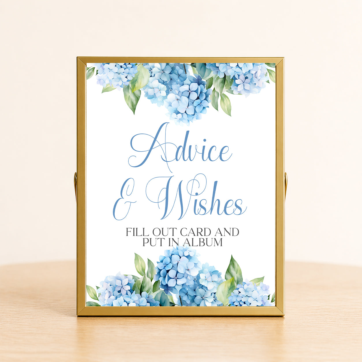 Hydrangea advice and wishes sign with blue floral design displayed in gold frame for bridal shower guest message station.