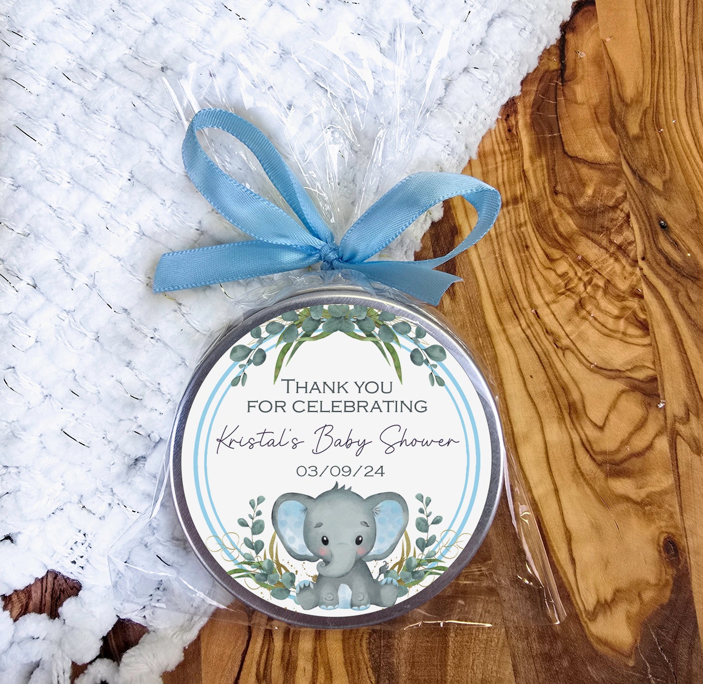 a small tin with a blue ribbon around it