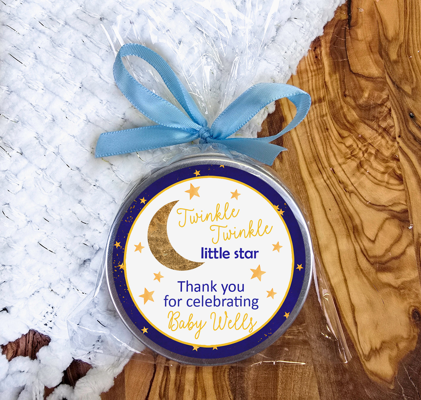 a baby shower tag with a blue ribbon on it