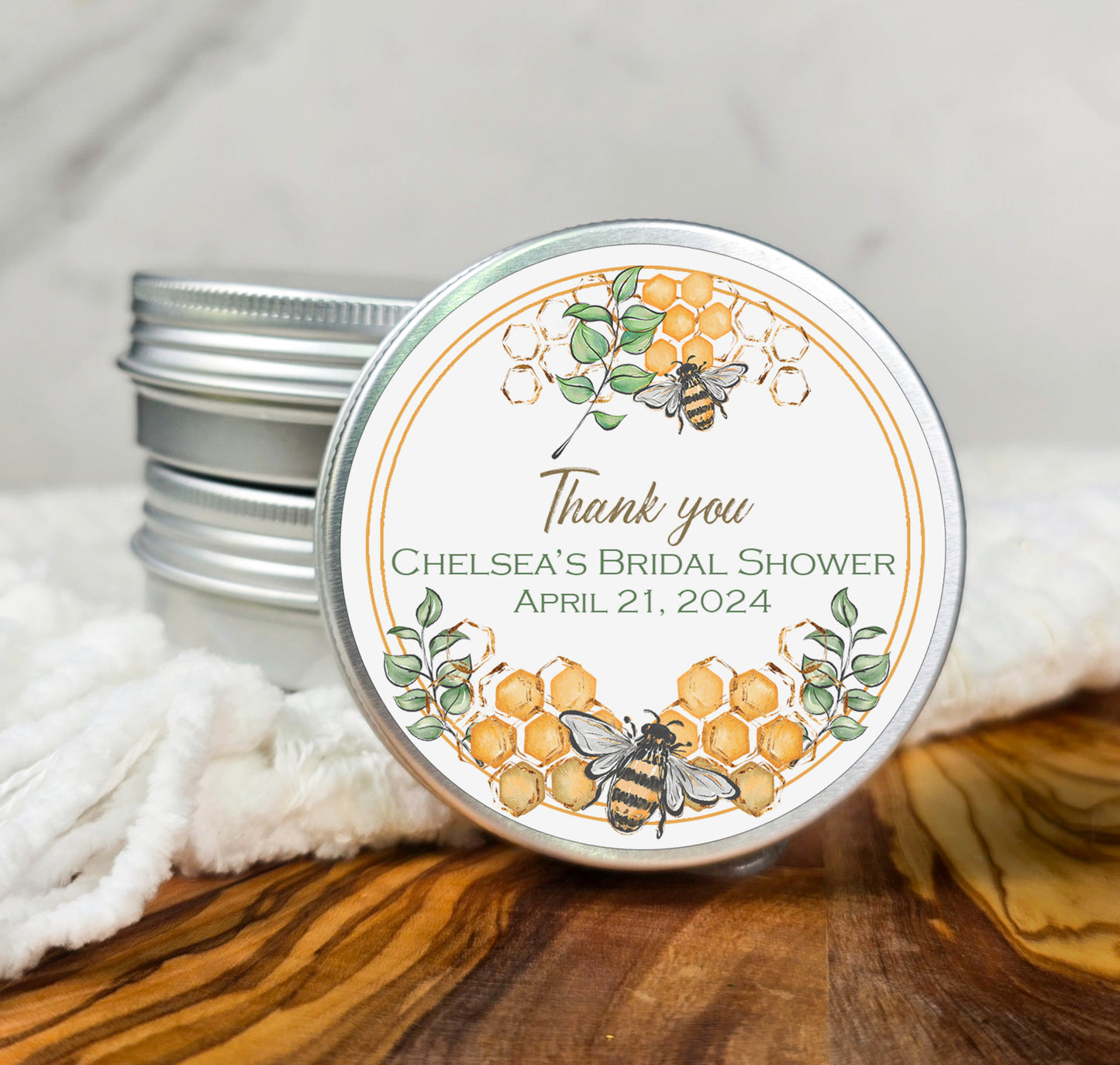 a jar of bees on a table with a white towel