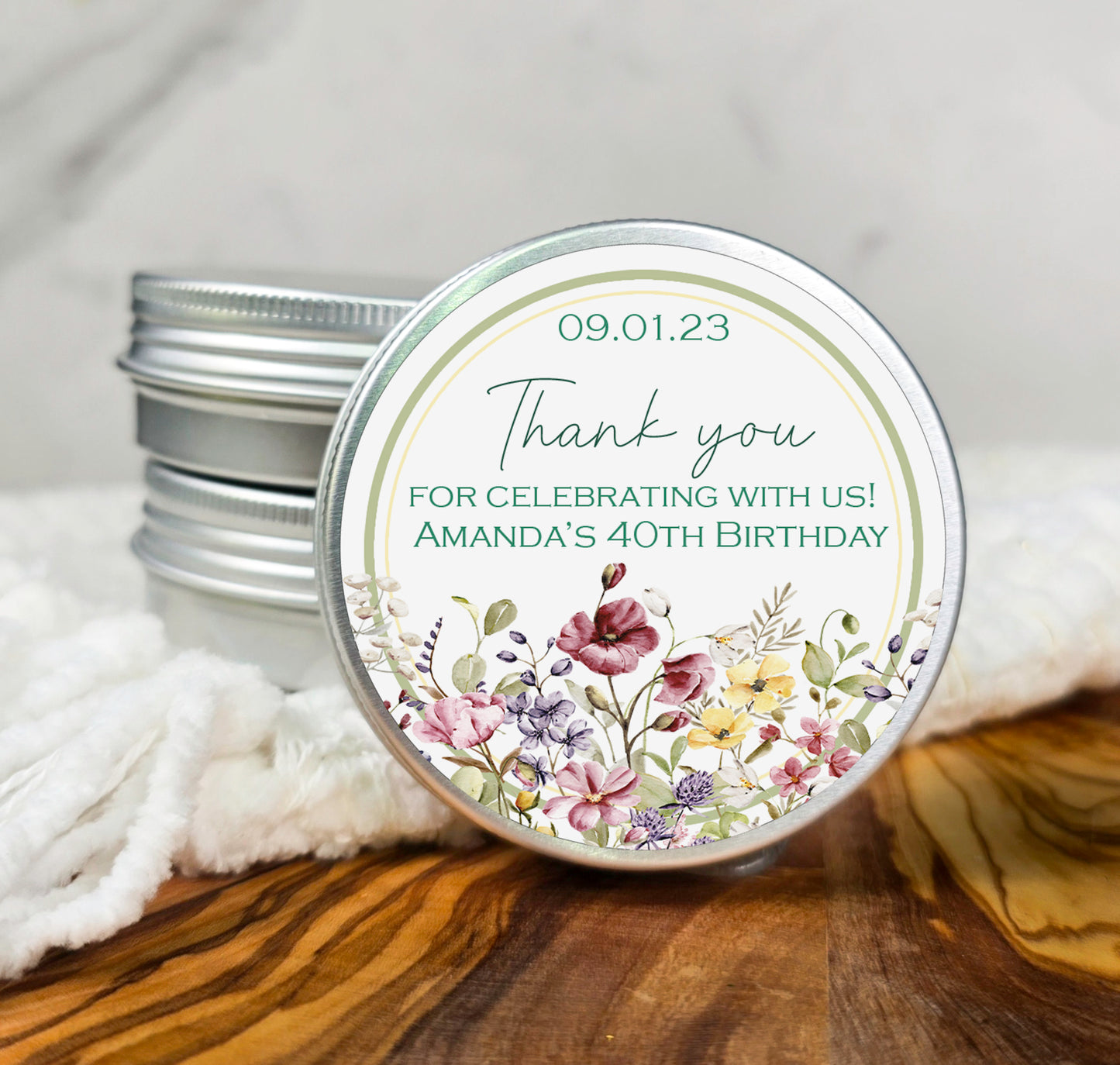 a tin of birthday candles with a thank you label