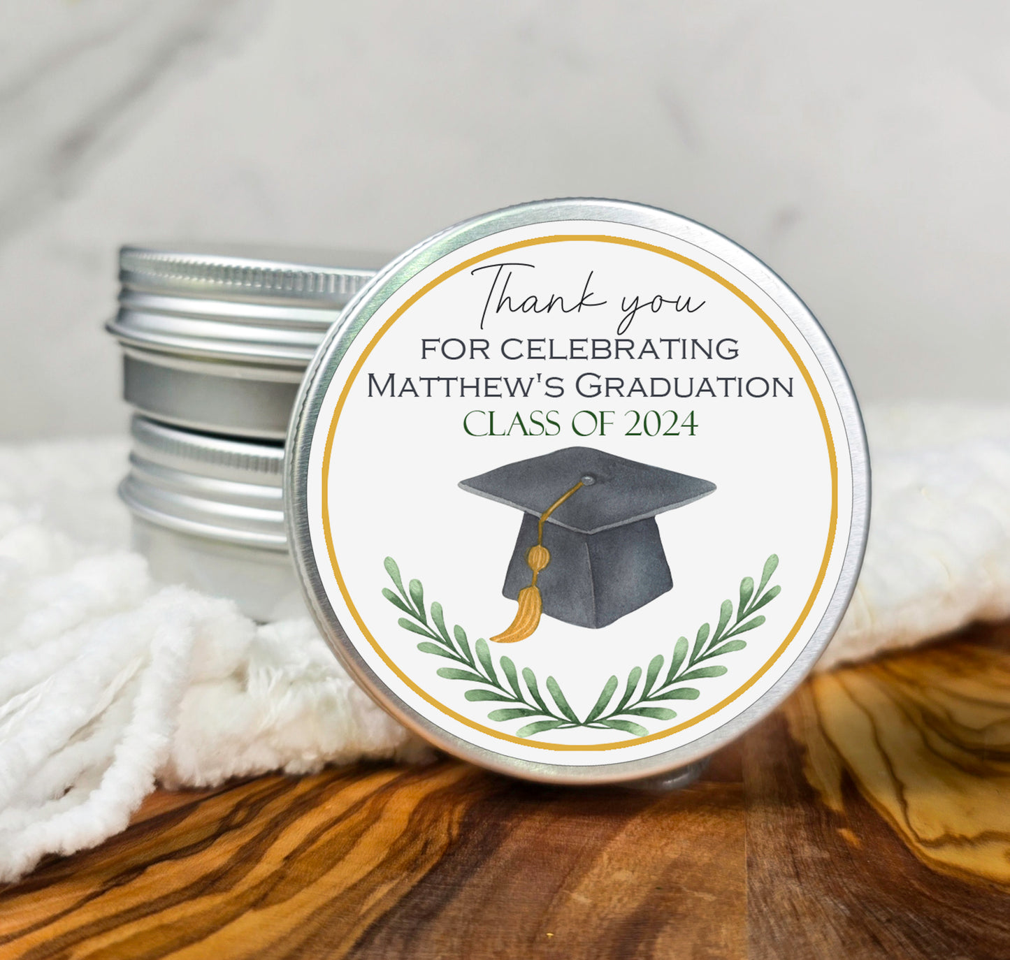 a personalized graduation party candle tin with a graduation cap on it
