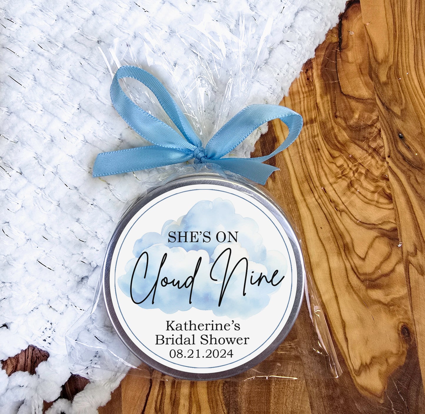 a round tin with a blue ribbon around it