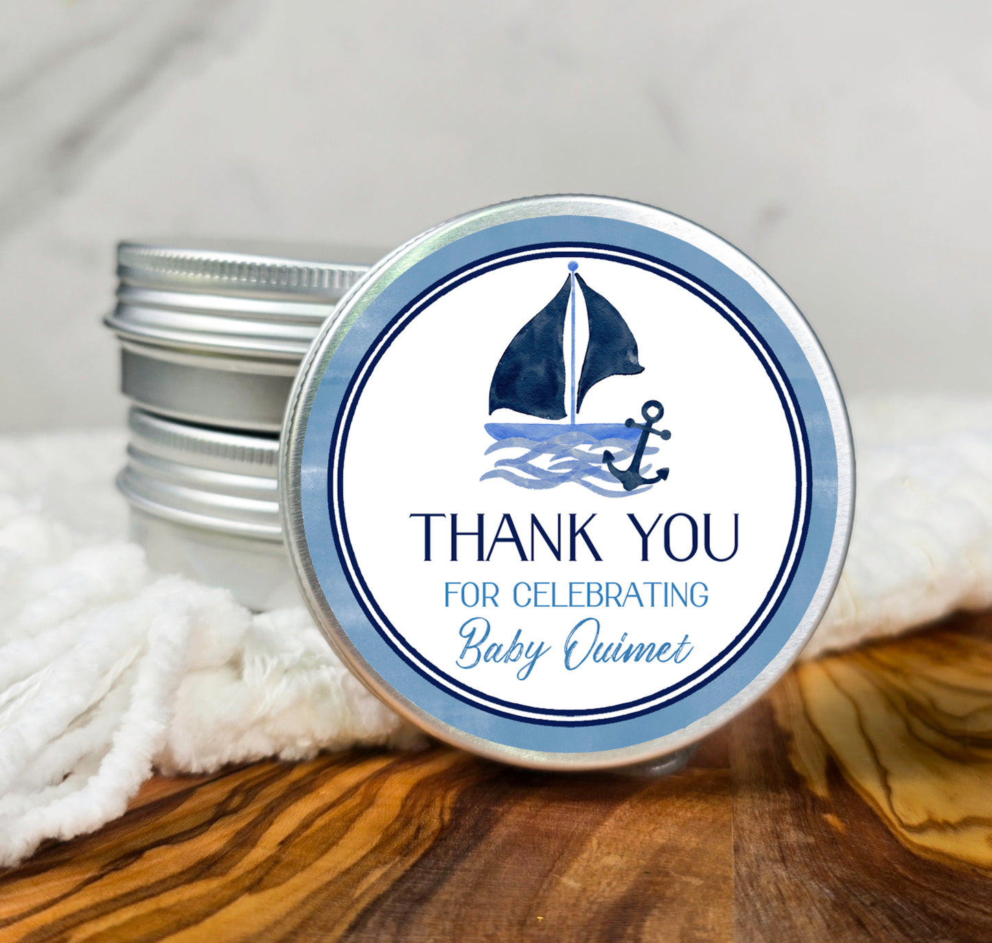 a small tin of baby humme with a sailboat on it