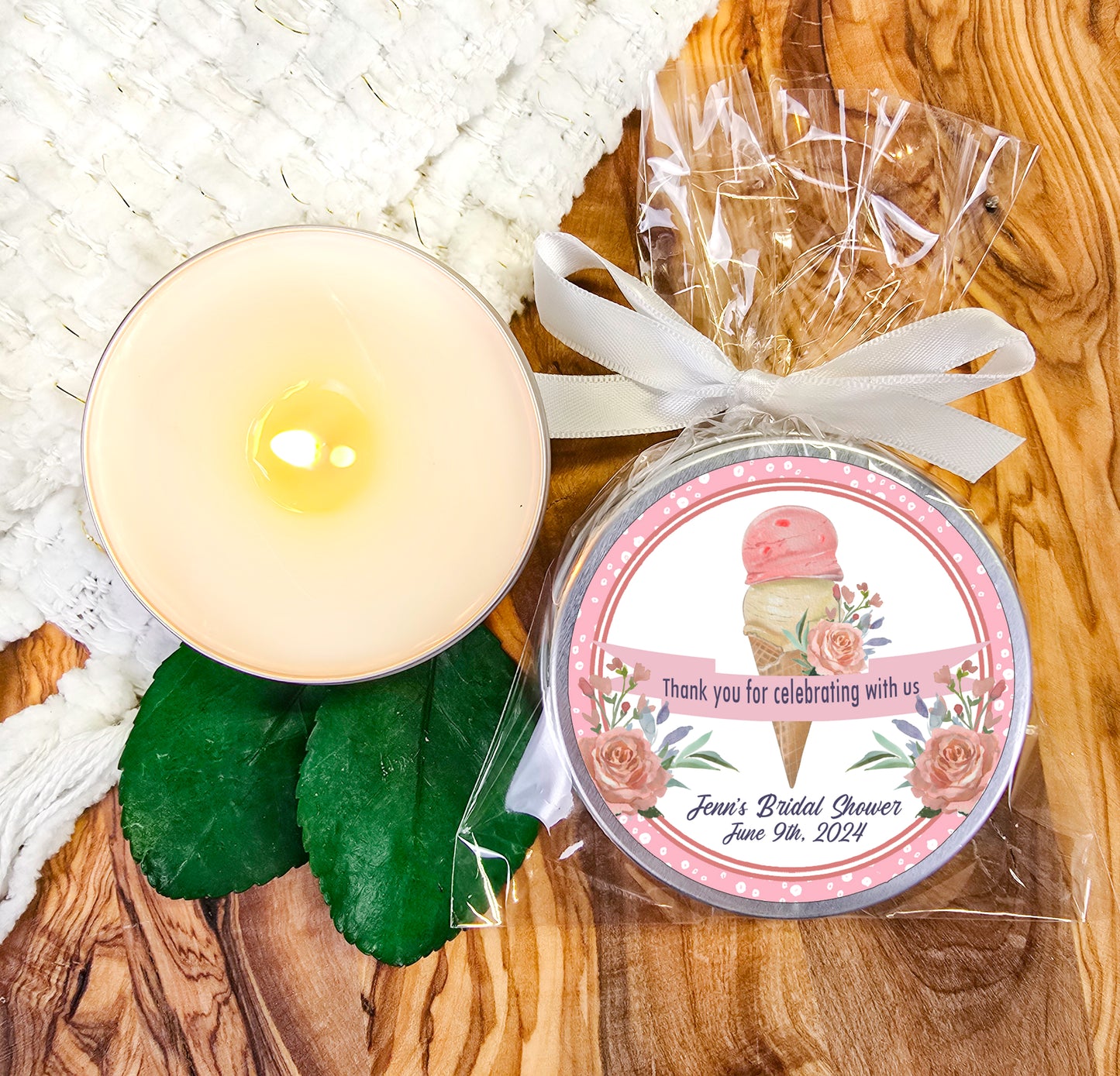 a candle and a small jar of soap on a wooden table