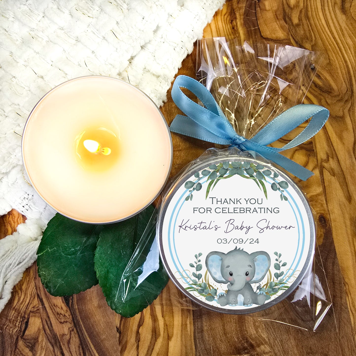 a candle and a personalized candle on a table