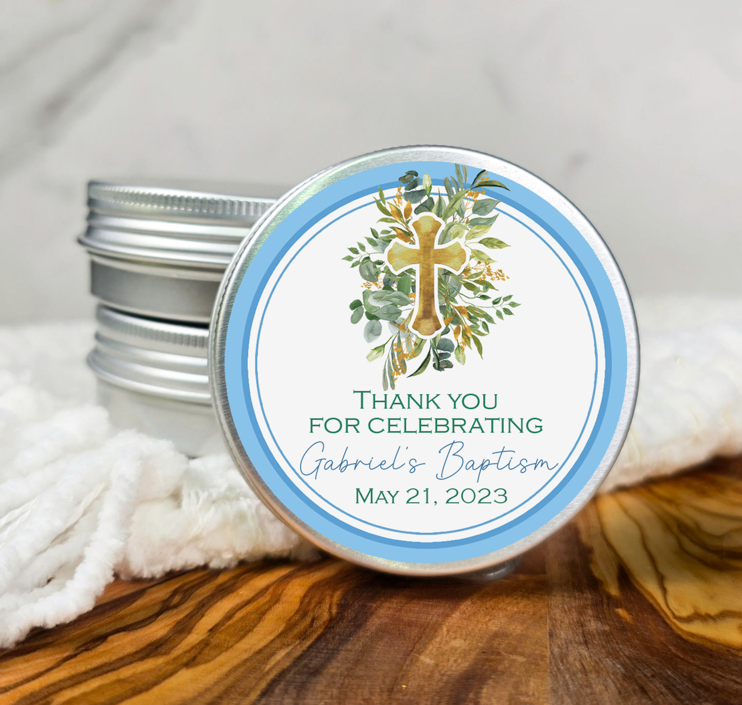 a small tin of candles with a cross on it