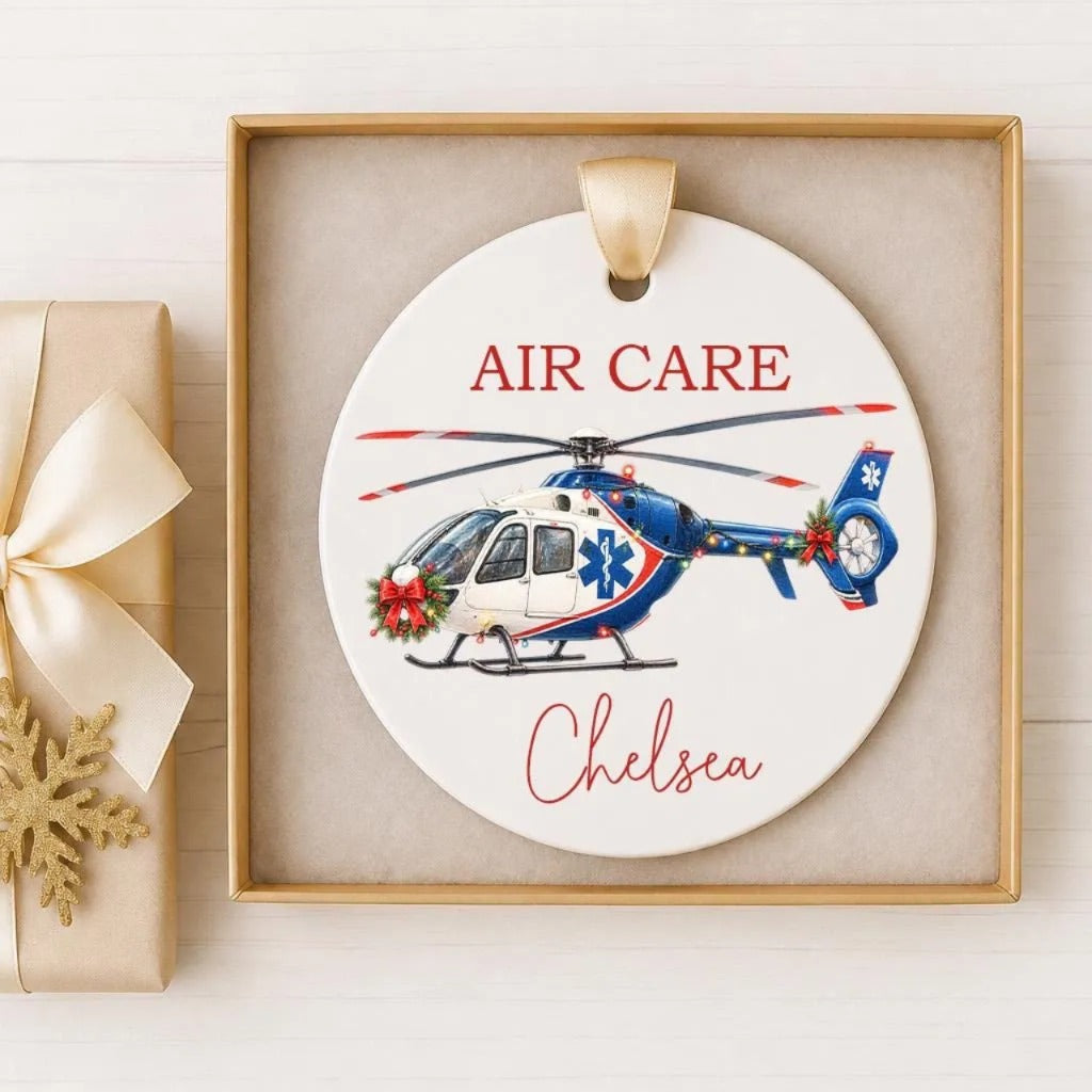 A ceramic ornament featuring a helicopter with the text "AIR CARE" and "Chelsea" written on it.