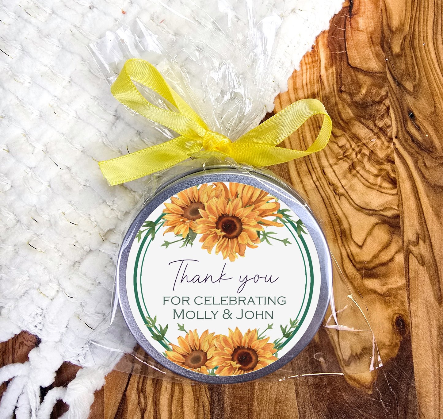 a small tin of sunflowers with a yellow ribbon