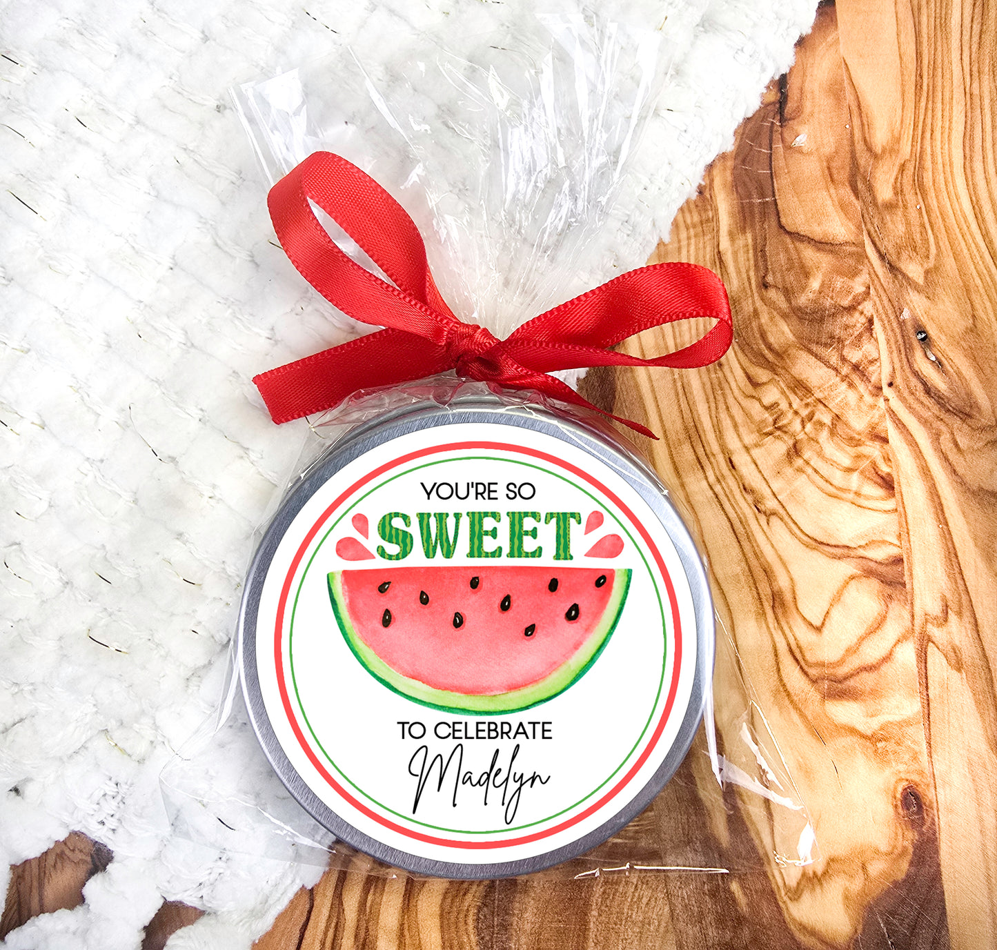 a watermelon birthday ornament with a red ribbon