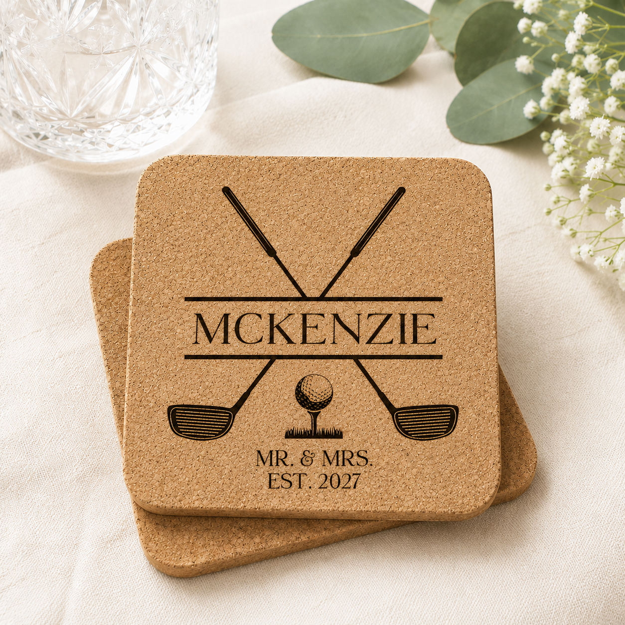 Personalized cork wedding coaster engraved with crossed golf clubs, golf ball, family name, and wedding year.