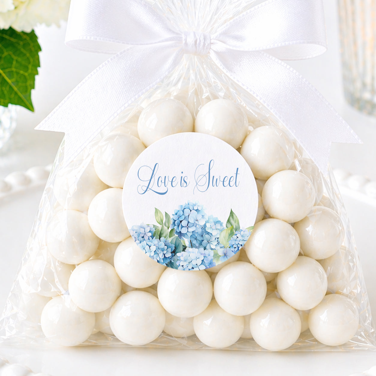 Hydrangea love is sweet stickers with blue floral design applied to favor bags for bridal shower or wedding favors.