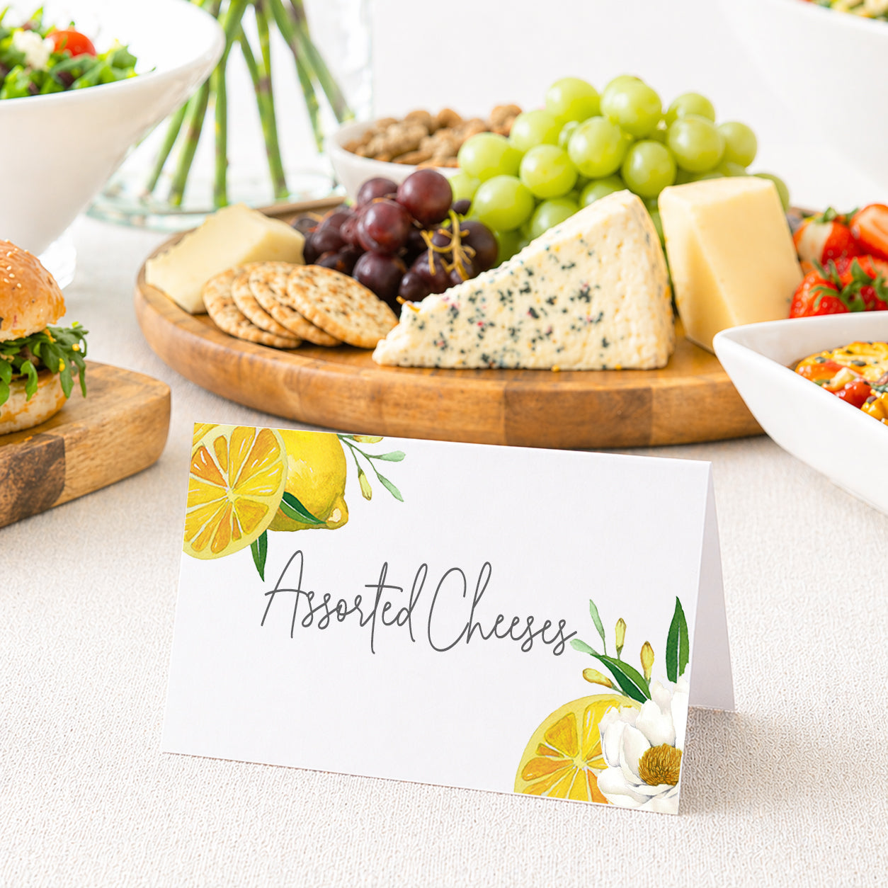Amalfi Coast lemon place card labeled and displayed on table with charcuterie board, used for buffet food labeling at bridal shower or wedding.