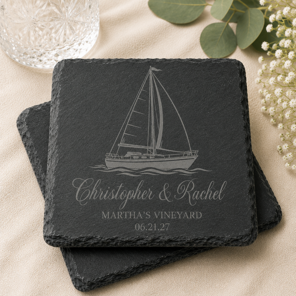 Personalized engraved slate coaster featuring sailboat design with custom names, wedding location, and date for coastal wedding favors.