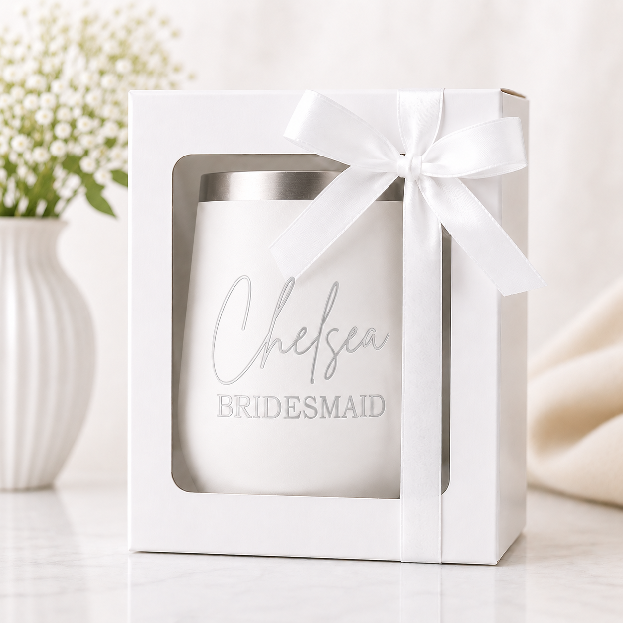 Personalized white bridesmaid wine tumbler displayed in a white gift box with a satin ribbon bow. Features a custom laser-engraved name and bridal party title with a subtle tone-on-tone design, creating an elegant bridesmaid proposal gift, maid of honor gift, or wedding party keepsake.