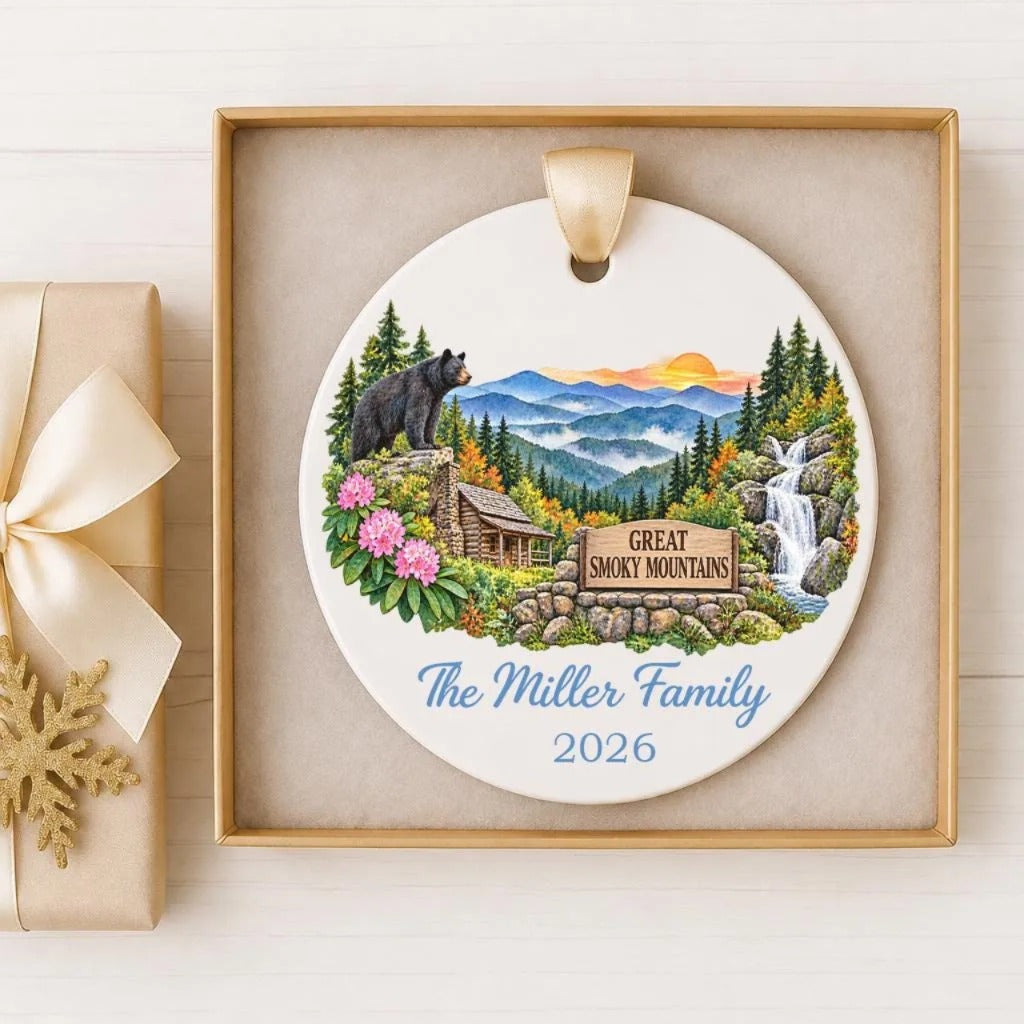 A decorative ornament featuring a black bear, a cabin, and a waterfall, with the text "The Miller Family" and "2026" below it.