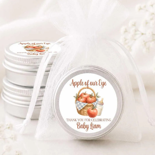 a set of silver tin containers with white labels, each containing a label that reads "Apple of our Eye" and "Thank you for celebrating Baby Liam".