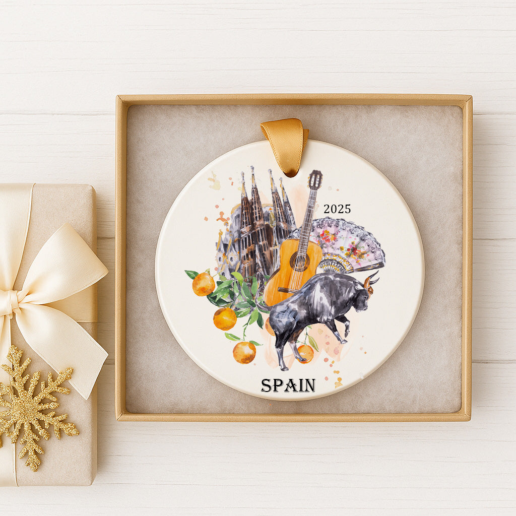 A decorative ornament featuring a bull, a guitar, and various fruits, including oranges and apples, along with the text "SPAIN" and the year "2025".